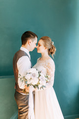 Modern ceremony in European style. Beautiful wedding couple in a bright Studio.