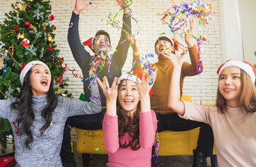 Group of young smile people in winter season playing and feel funny from paper firework for...