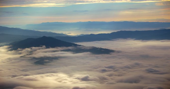 Scene time lapse of misty over at mountain with misty clouds fast movement, Nature of sunrise background