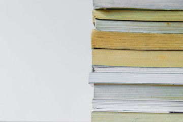 Front view of stacked books at white background