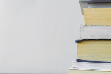 Front view of stacked books at white background