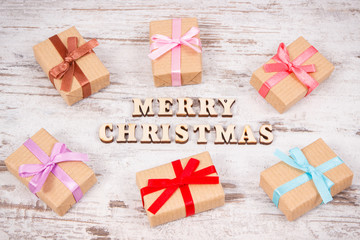 Inscription Merry Christmas and wrapped presents for holidays