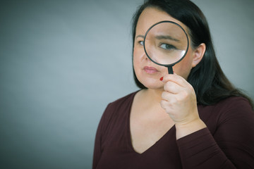 Adult woman with magnifying glass