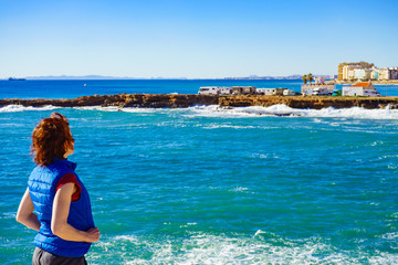 Tourist woman on sea cliffs in Spain