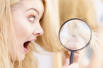 Woman magnifying her split ends hair