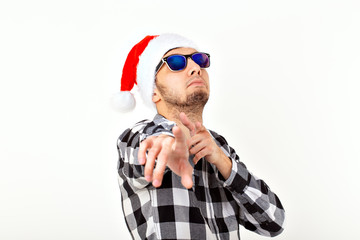 Portrait of a funny young man in Santa Claus hat and beard on white background. Christmas.