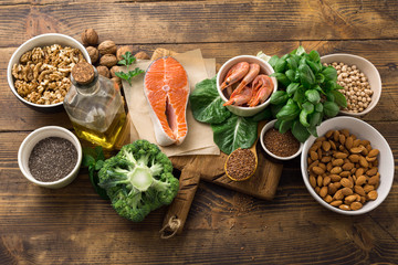 Health food fitness. Food sources of omega 3 and omega 6 on dark background top view. Foods high in...