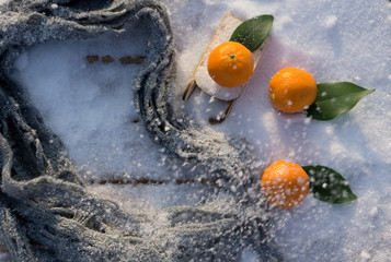 Clementines tangerines  as Christmas decor over snow background.