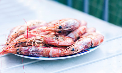 Boiled red shrimps prawns on the plate, seafood from the fish market of Catania, Sicily.