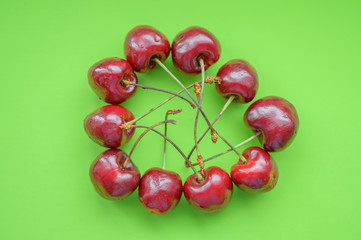 Natural looking cherry on a green background. Selective focus.