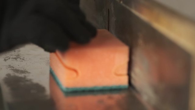 Red-hot spiral cuts paralon sponges, production of household goods, curly trimming, temperature exposure, trimming of excess parts of paralon, shaping, work on conveyor belt, small business, close-up