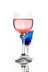 rose wine and blue coctail in beautiful vintage crystal glasses on white wall background, with copy space. Wine list, bar drink menu, wine boutique or degustation, Vertical crop concept