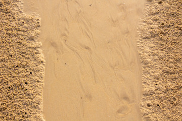Detailed close-up on the sandy beach surface with high resolution.