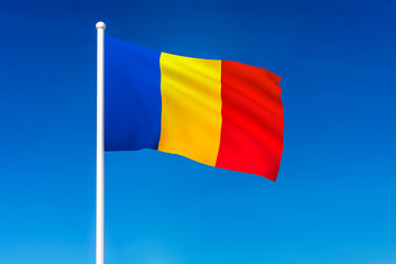 Waving flag of Romania on the blue sky background