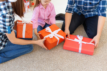 Holidays and presents concept - Close-up of family opening gifts at Christmas time