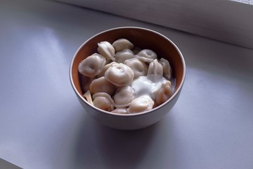 Dumplings with sour cream on the table