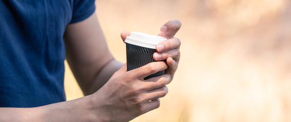 Coffee cup in young hands