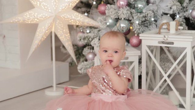 Beautiful one-year-old girl in a New Year's decor. Happy New Year 2020.