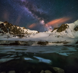 Milky Way over the moraine lake in Tien Shan mountains