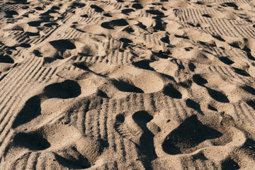 Fototapeta na wymiar Footprints in the sand. The sand on the beach. Summer and the sun.
