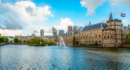 Binnenhof palace complex with pond and fountain in the foreground and business district in the background, The Hague, Netherlands
