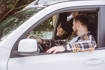 couple inside car talking ready for road trip