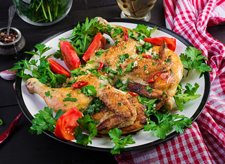 Turkish, georgian cuisine. Grilled fried roast Chicken Tabaka in plate on wooden background.