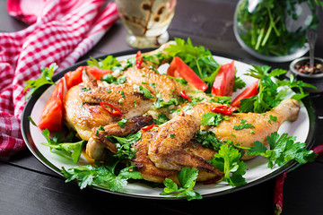 Turkish, georgian cuisine. Grilled fried roast Chicken Tabaka in plate on wooden background.