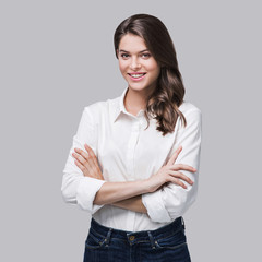 Beautiful young business woman portrait. Smiling cute girl with long hair studio shot. Isolated on...