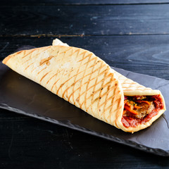 Doner kebab (shawarma or doner wrap). Grilled chicken on lavash (pita bread) with fresh vegetables....