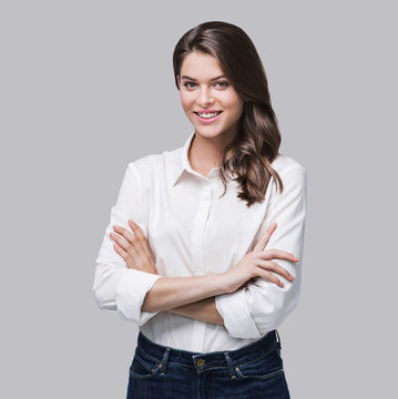 Beautiful Young Business Woman Portrait. Smiling Cute Girl With Long Hair Studio Shot. Isolated On Gray Background