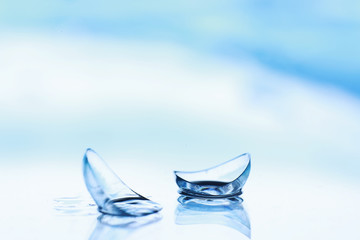 Tools for vision correction. Glasses and lenses with diopters on the background of splashes and...