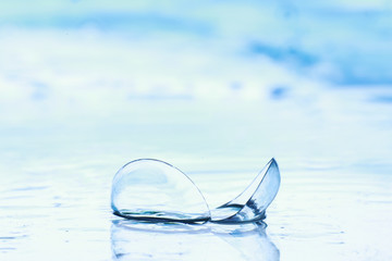 Tools for vision correction. Glasses and lenses with diopters on the background of splashes and...