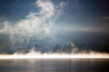 Fototapeta na wymiar Lovely autumnal landscape with fog over the lake.