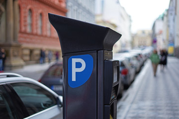 Modern solar car parking pay station on a busy street in city centre