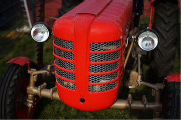 Historic vintage red tractor on field
