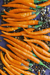 Hot orange pepper. Chilean pepper on a black.