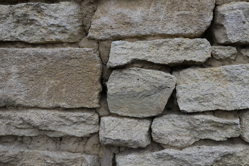 Old stone wall, with beautiful masonry of gray stone