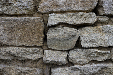 Old stone wall, with beautiful masonry of gray stone