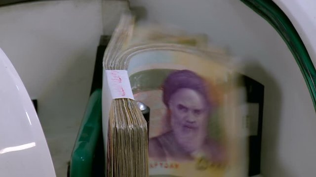 Inside Iranian bank, Banknote counter counts 50000 rial bills
