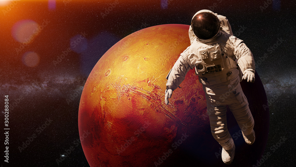 Wall mural astronaut during a space walk in orbit of planet mars