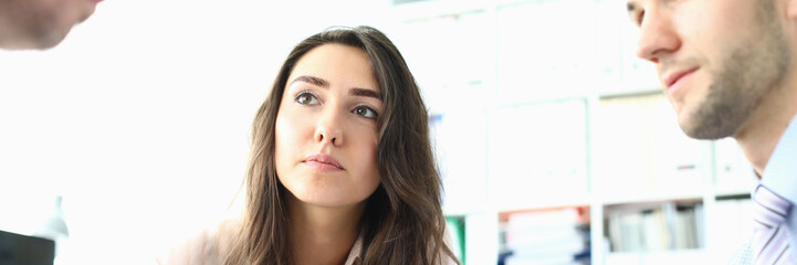 Fototapeta premium Portrait of gorgeous businesswoman looking at partner and discussing important strategy with friendly bearded male colleague. Biz meeting concept. Blurred background