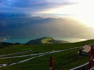 Scenic and panoramic view of Mountain lake with valley, trees and mountain range from top of hill