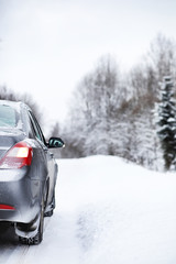 The car stands on a snow-covered road