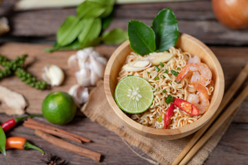 Close-up shot Instant noodles with lemon shrimp chilli hot and spicy on old wooden table select focus shallow depth of field