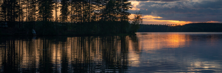 Lake at sunset with reflection in Finland