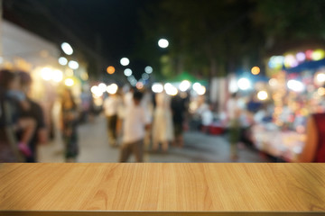 Empty dark wooden table in front of abstract blurred bokeh background of restaurant . can be used for display or montage your products.Mock up for space.