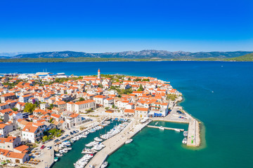 Fototapeta na wymiar Croatia, Island of Murter, beautiful old traditional coastal town of Betina on Adriatic sea, drone aerial