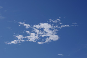 A lone group of clouds up in a deep blue California sky