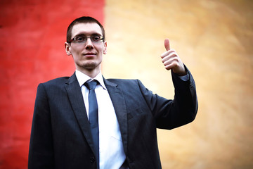 A man in a suit lies on a brick floor